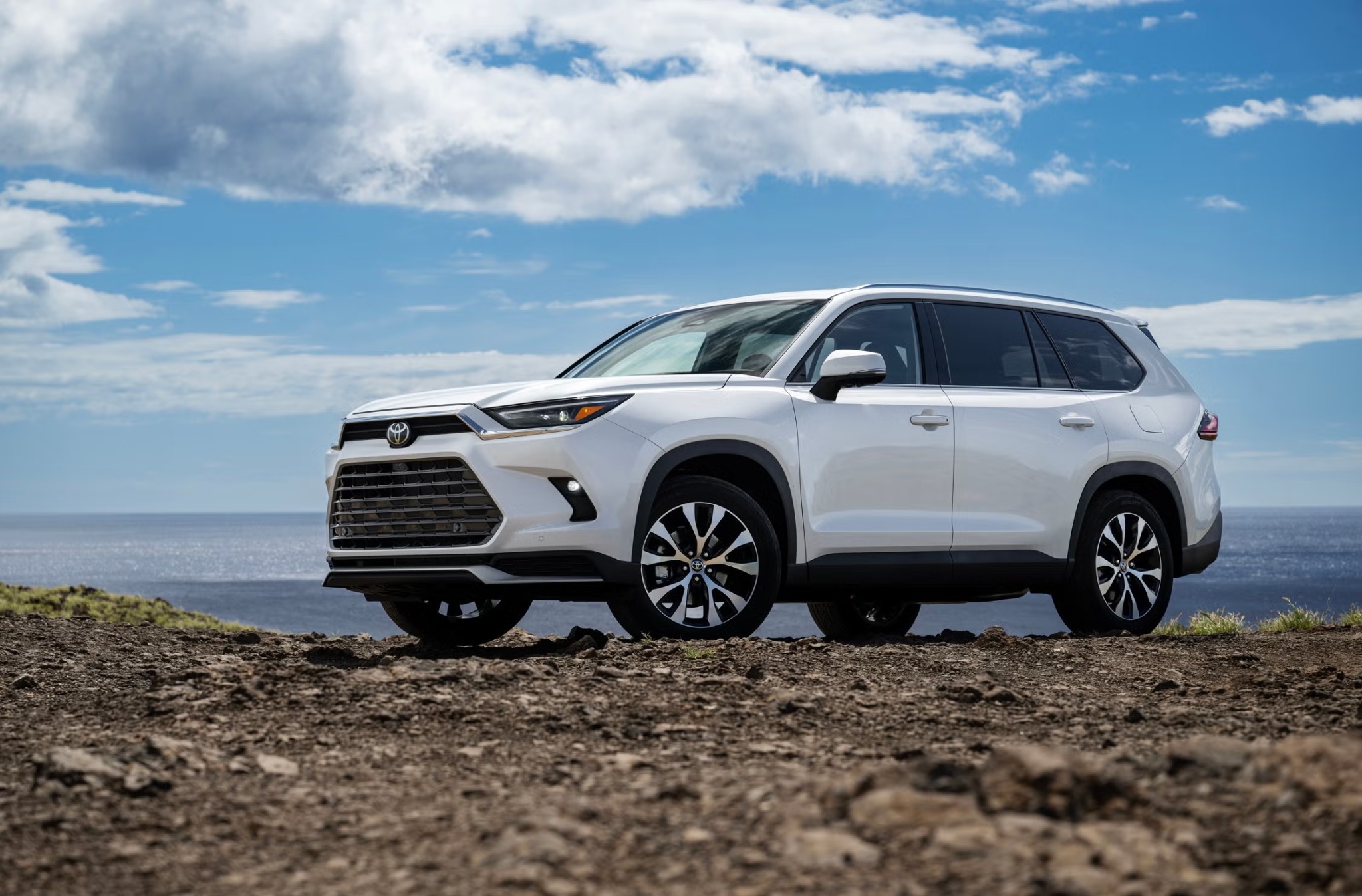 White Toyota Grand Highlander beside the coast